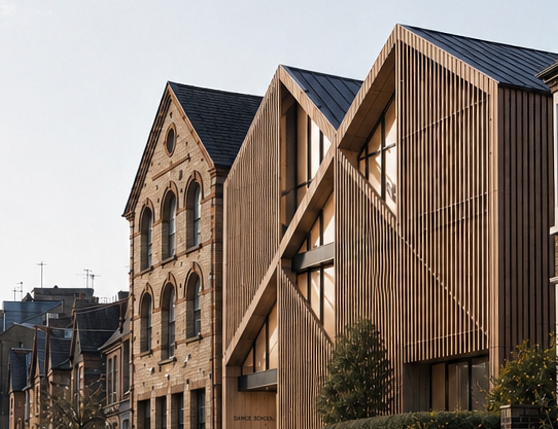 A closer view of the Rickett Architects visualisation from along the street: the two timber-screened gables of the tested building beside the retained brick dance school building, with bicycles and a hedge at the pavement