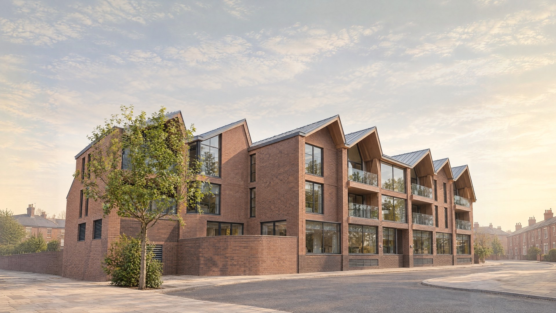 A Rickett Architects visualisation of the design granted in 2015: a three storey red brick building on a street corner with a sawtooth roof of seven steep zinc gables, timber lined gable ends, glass balconies, large ground floor office windows over a darker brick plinth, a curved brick terrace wall and a young street tree, under a pale morning sky