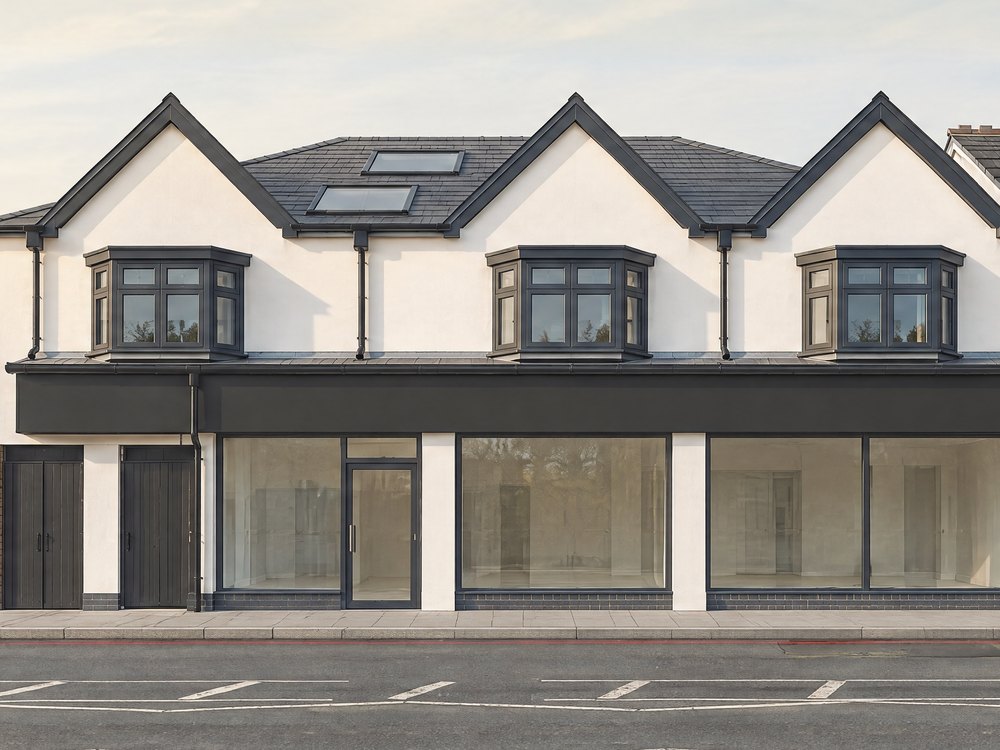 Detail of the visualisation: three white gables, each with a bay window, over the dark fascia