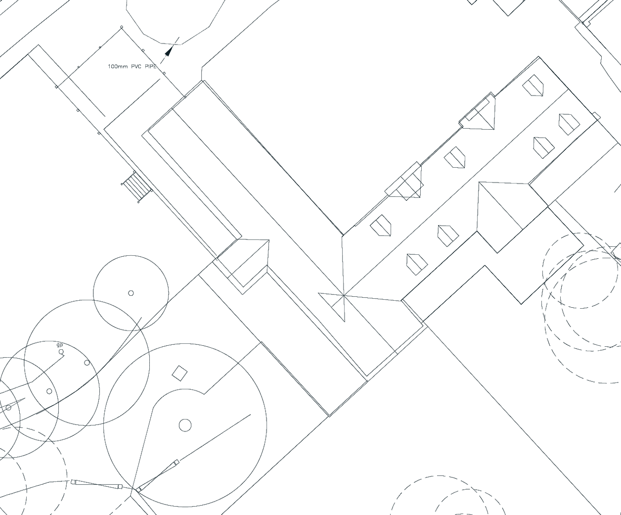 Approved site block plan: the converted building on the diagonal, with trees across the lawn in front