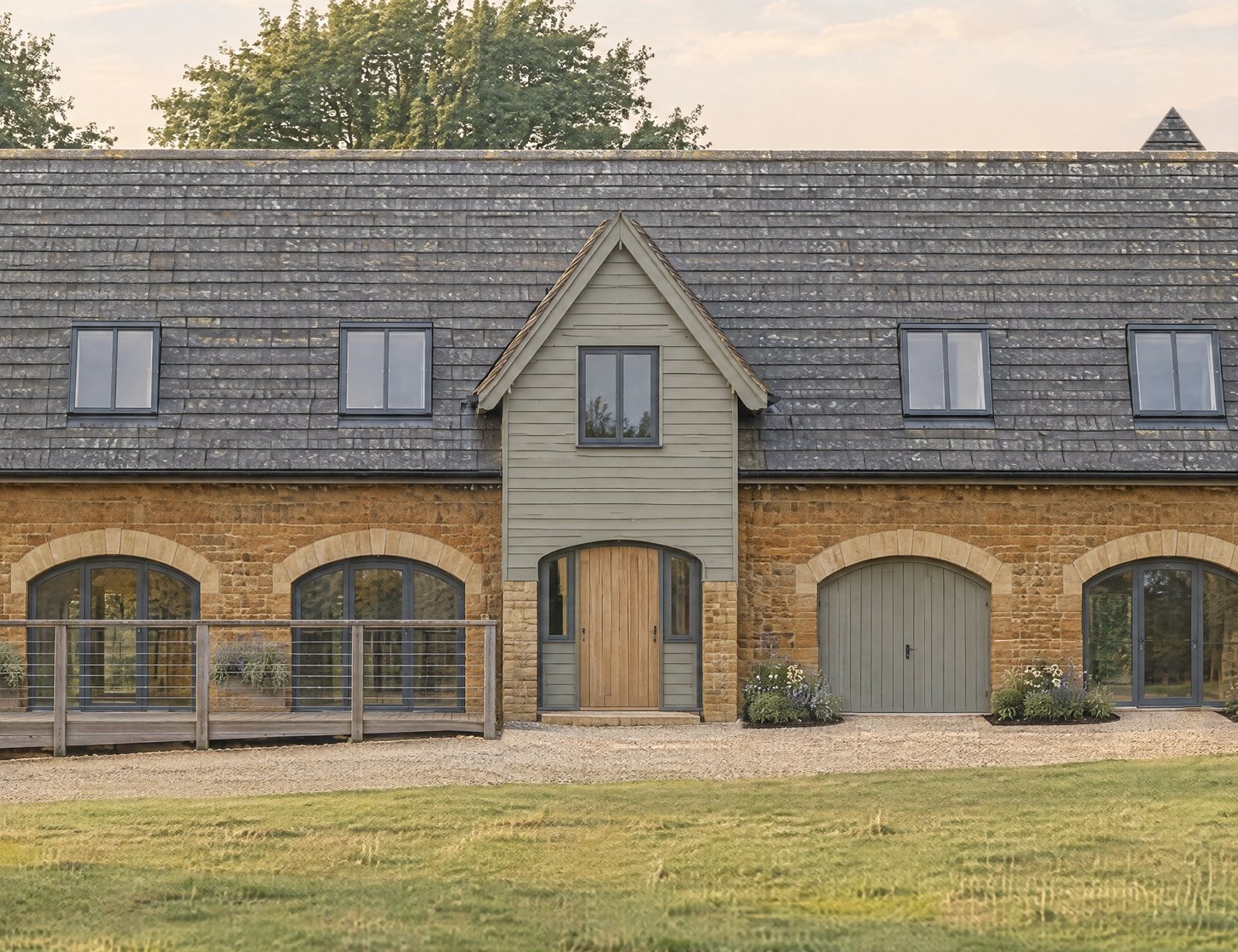Closer visualisation of the timber-clad entrance gable and its arched door, set between stone walls