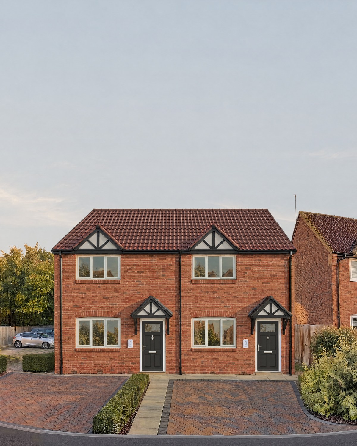 Visualisation of the new red-brick semi-detached pair on Montgomery Road, Whitnash, between older houses