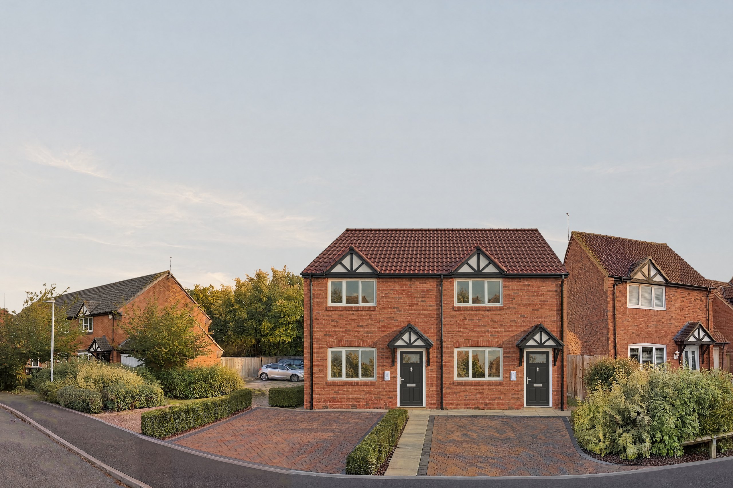 Visualisation of the new red-brick semi-detached pair on Montgomery Road, Whitnash, between older houses