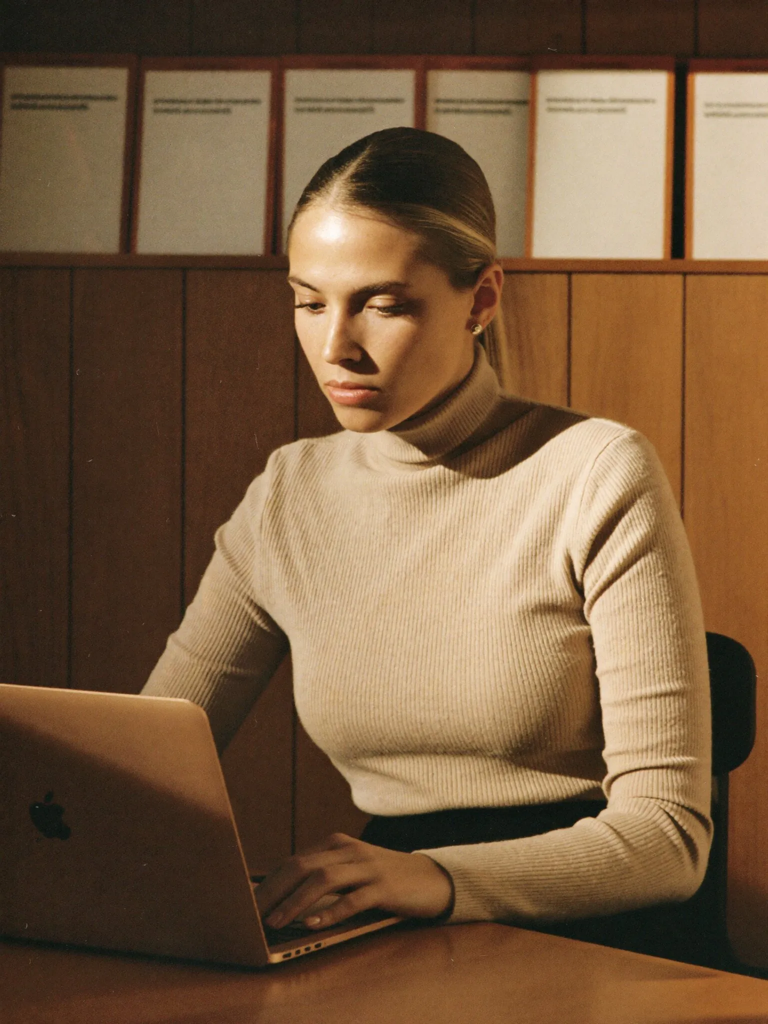 Services operations consultant working at a laptop
