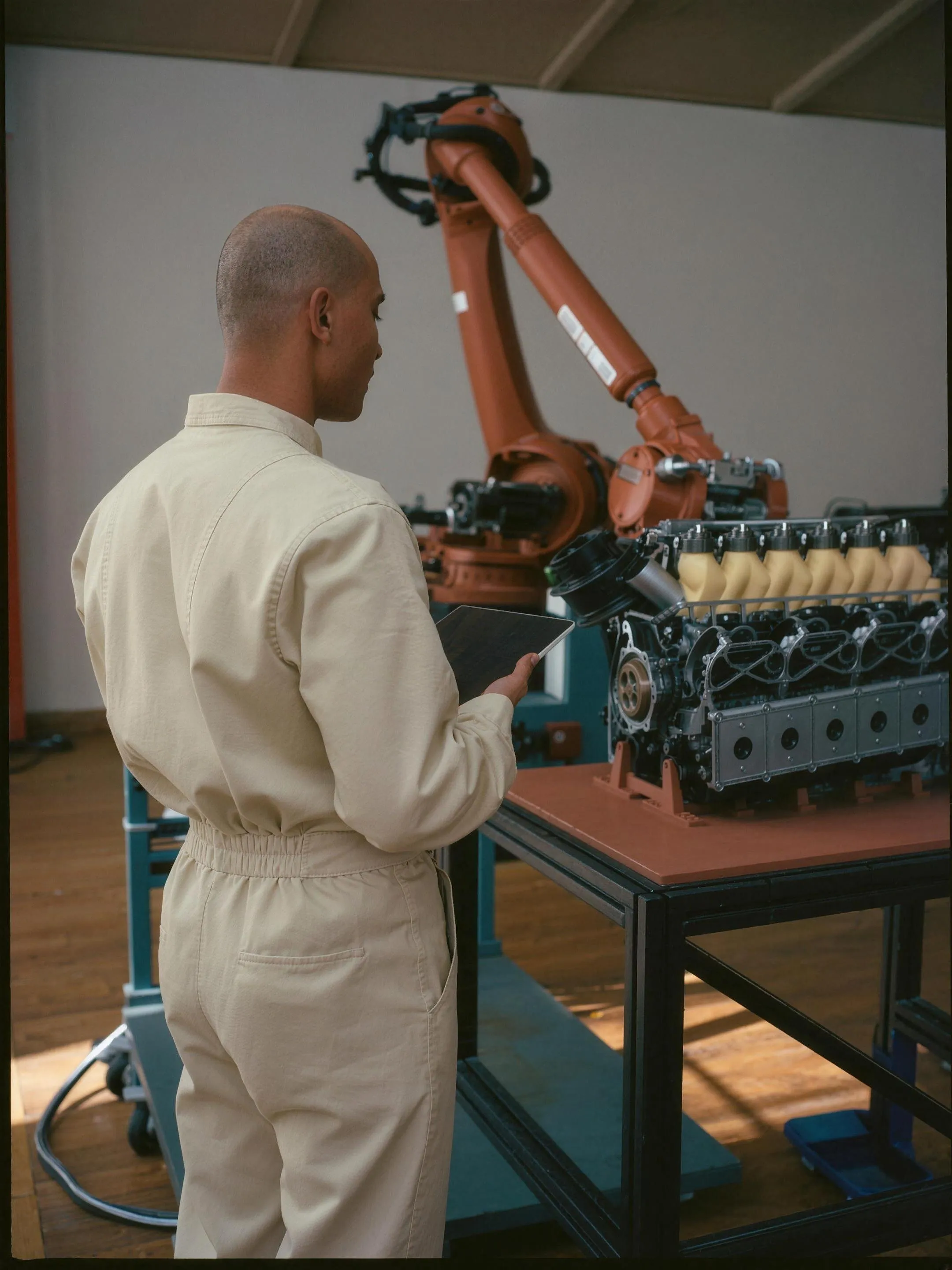 Engineer working on an engine assembly at a production station
