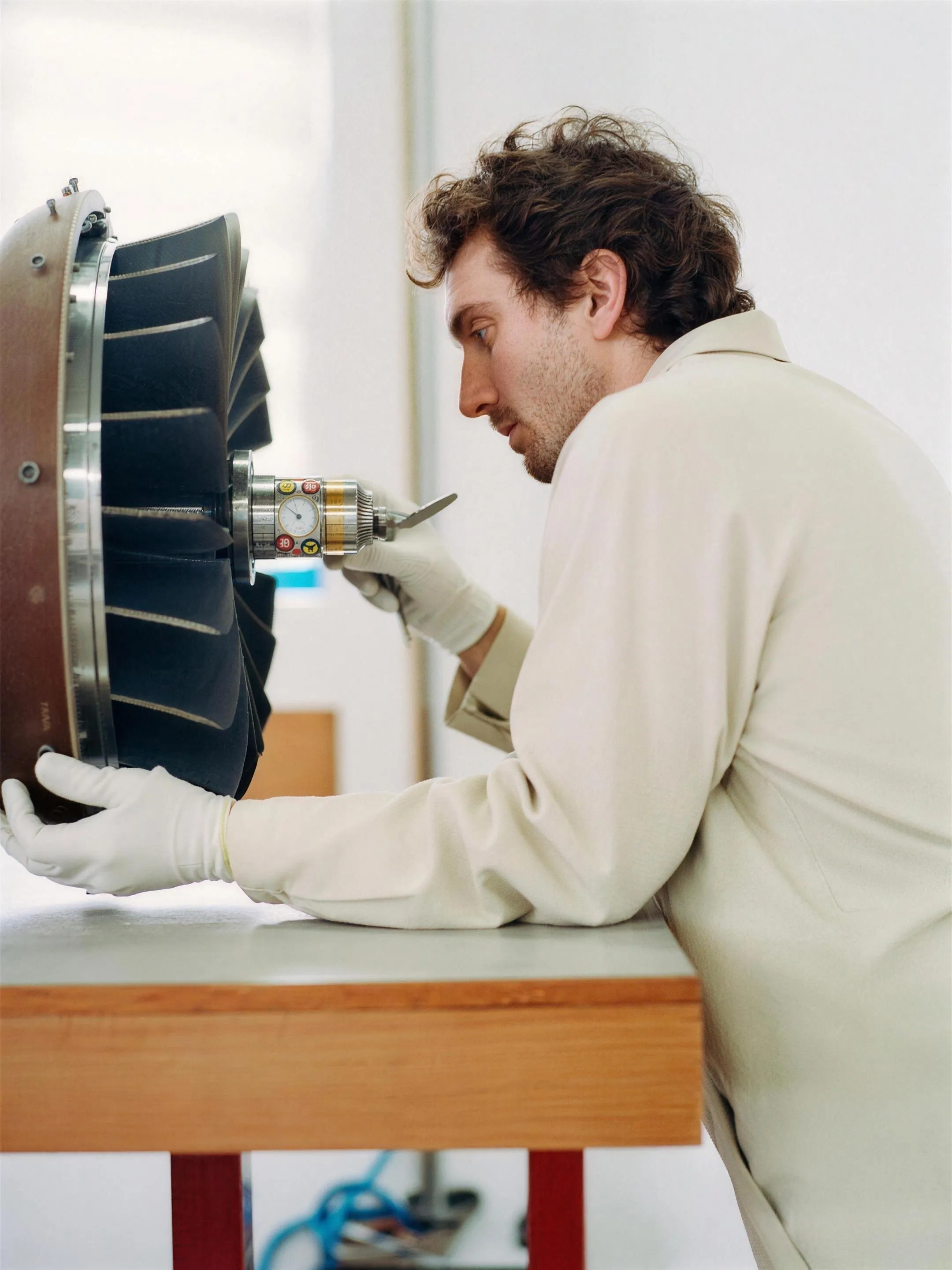 Technician examining a precision panel assembly at a workbench