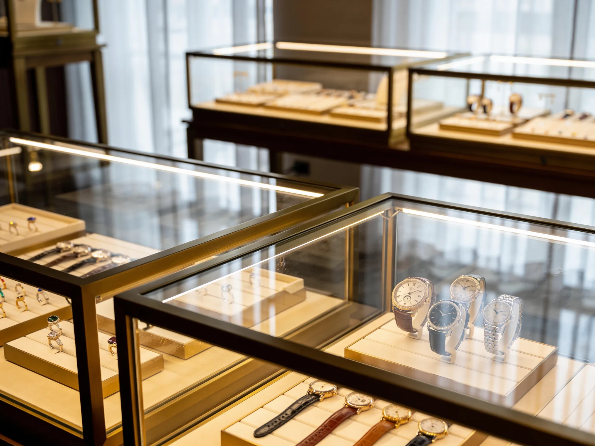 Independent jewelry store interior with illuminated display cases