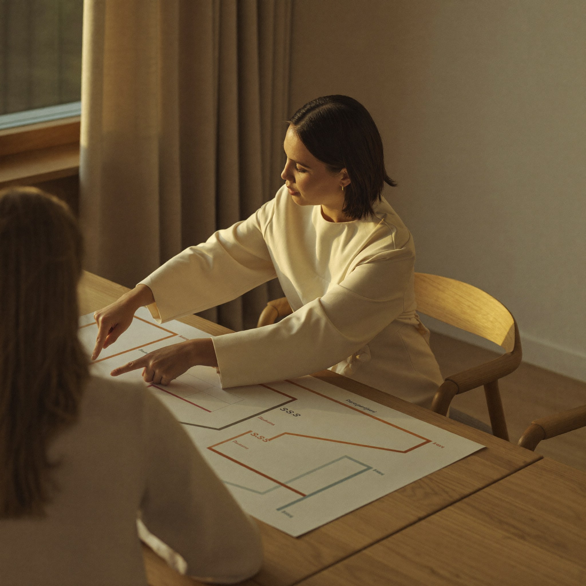 Consultant walking a client through a printed process map during an ERP Implementation engagement at Aedista