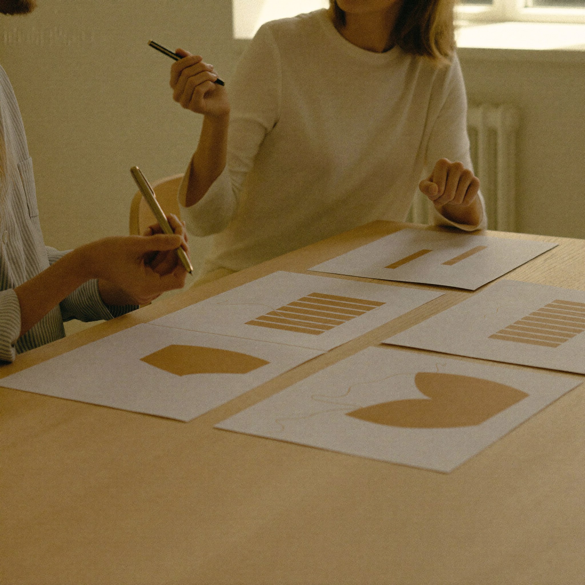 Analyst marking up printed charts spread across a table during a Data & Analytics engagement at Aedista