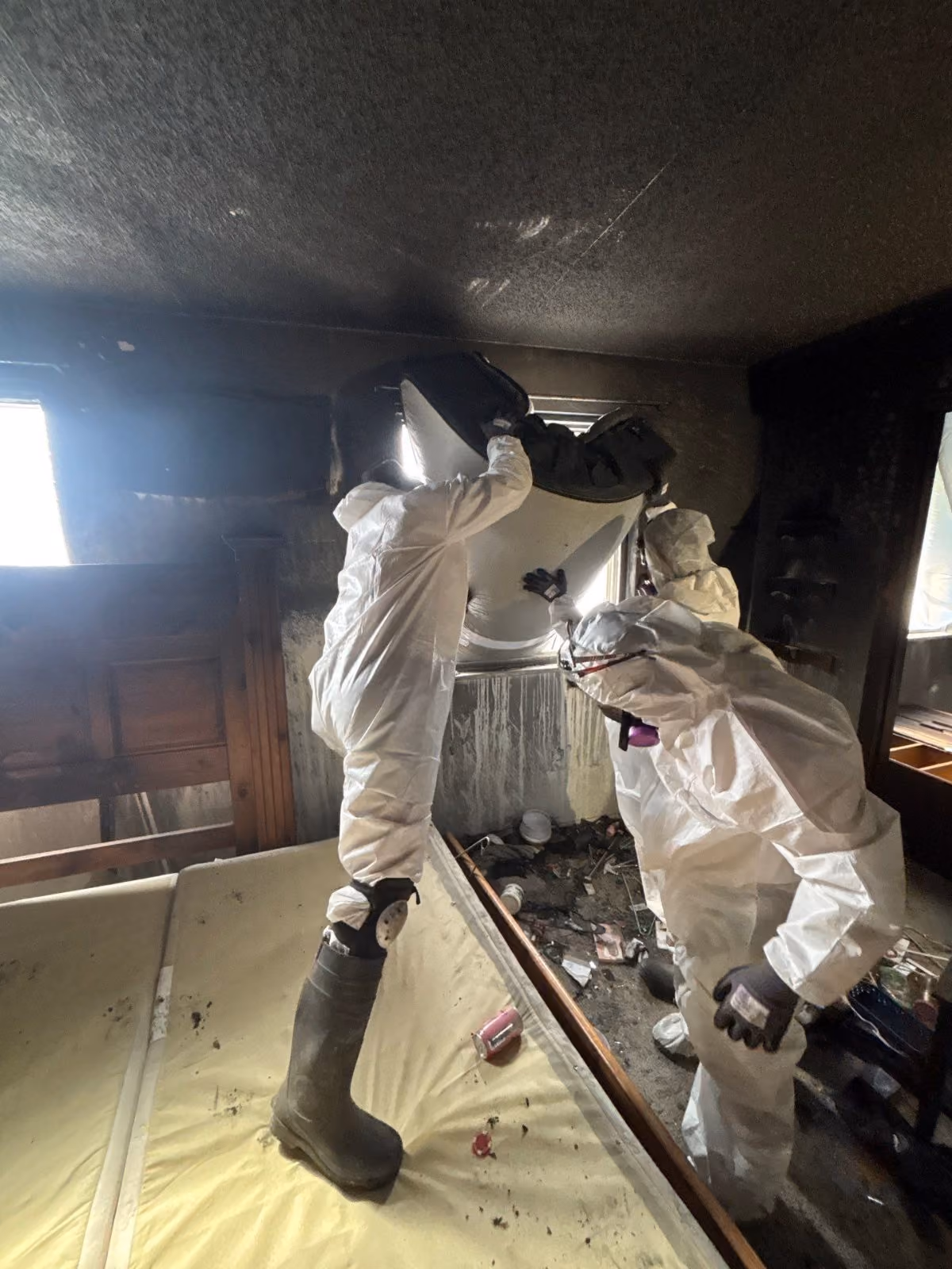 Crew cleaning soot from walls