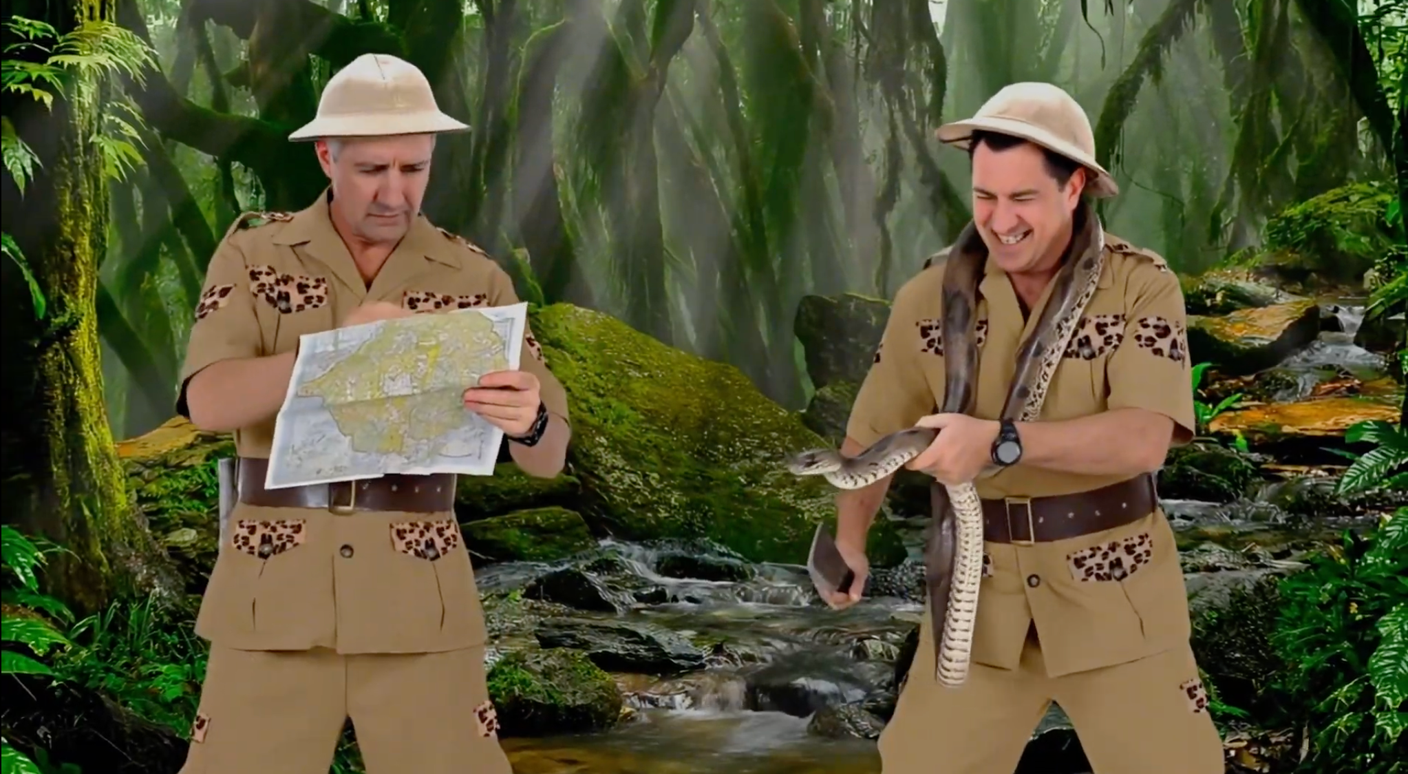 Two safari explorers holding a map and snake in a jungle