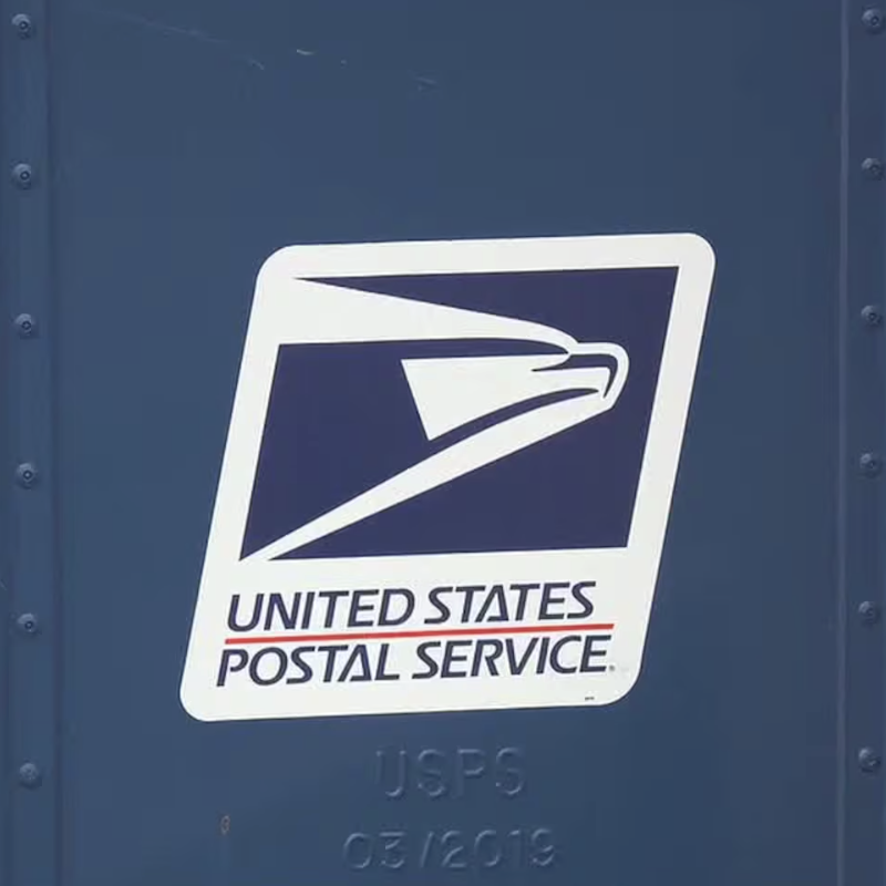 United States Postal Service logo on a blue mailbox