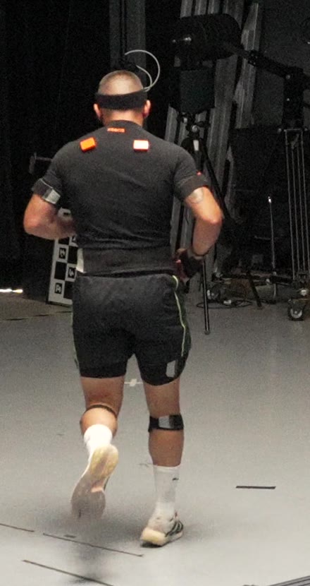 Athlete wearing the inertial motion-capture suit, sensor straps visible on head, shoulders, arms, thighs and shins
