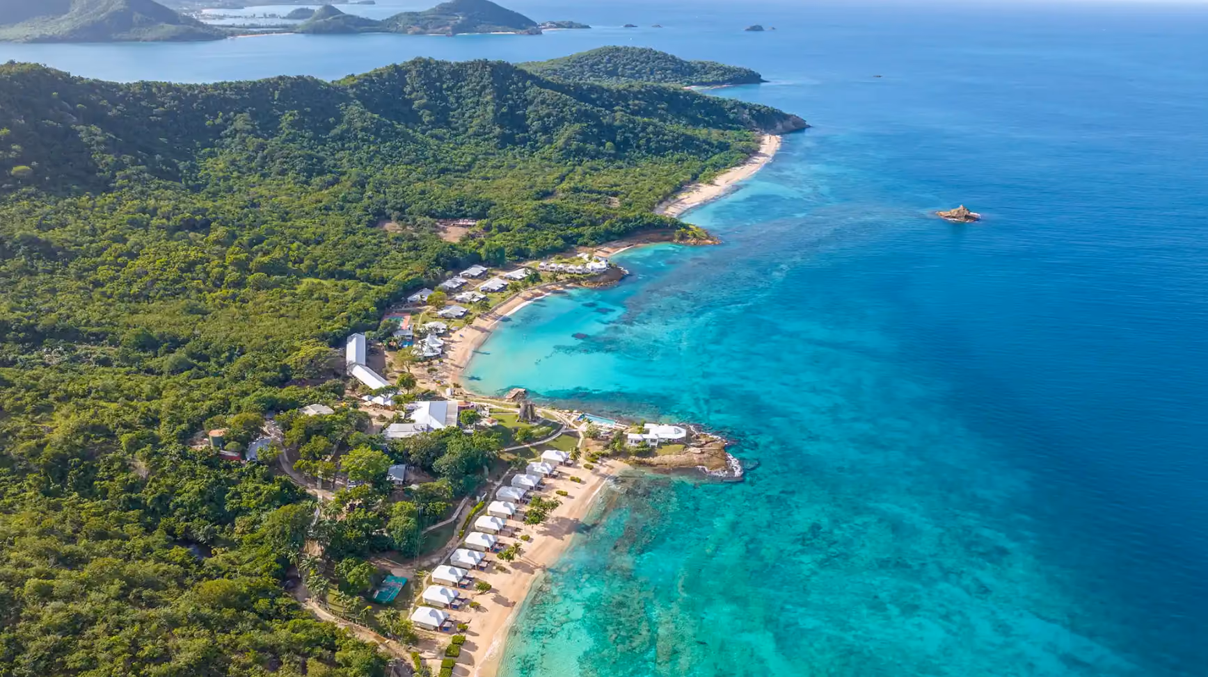 Aerial view of Hawksbill Resort cottages along the coastline with its beaches, Antigua