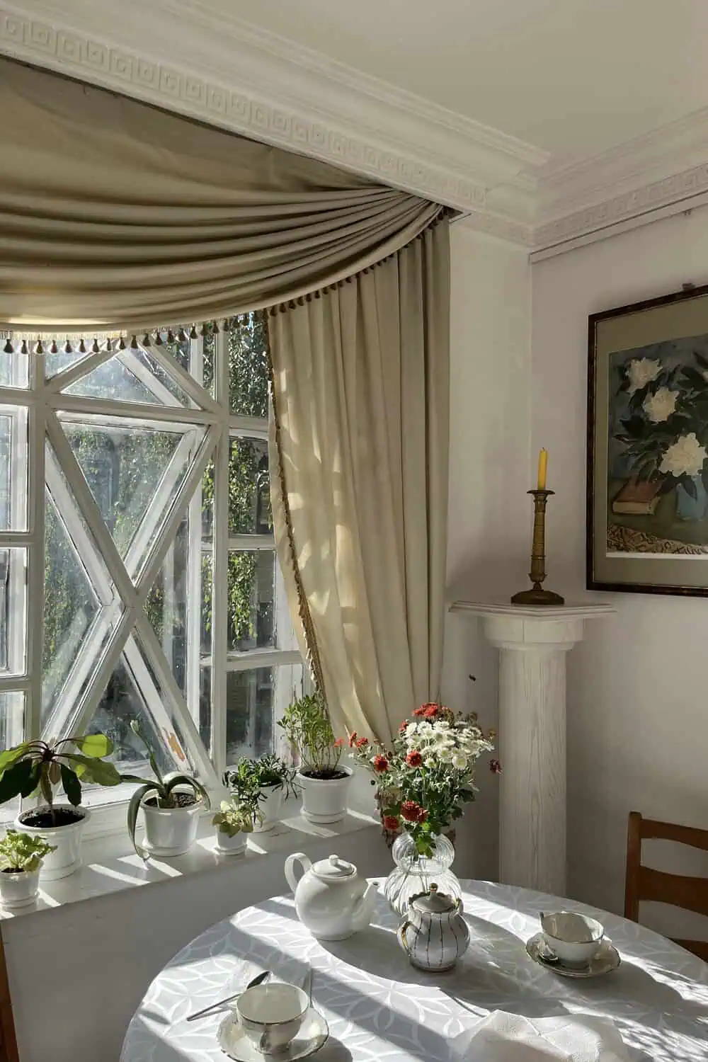 A table set for afternoon tea in a historic house dining room.