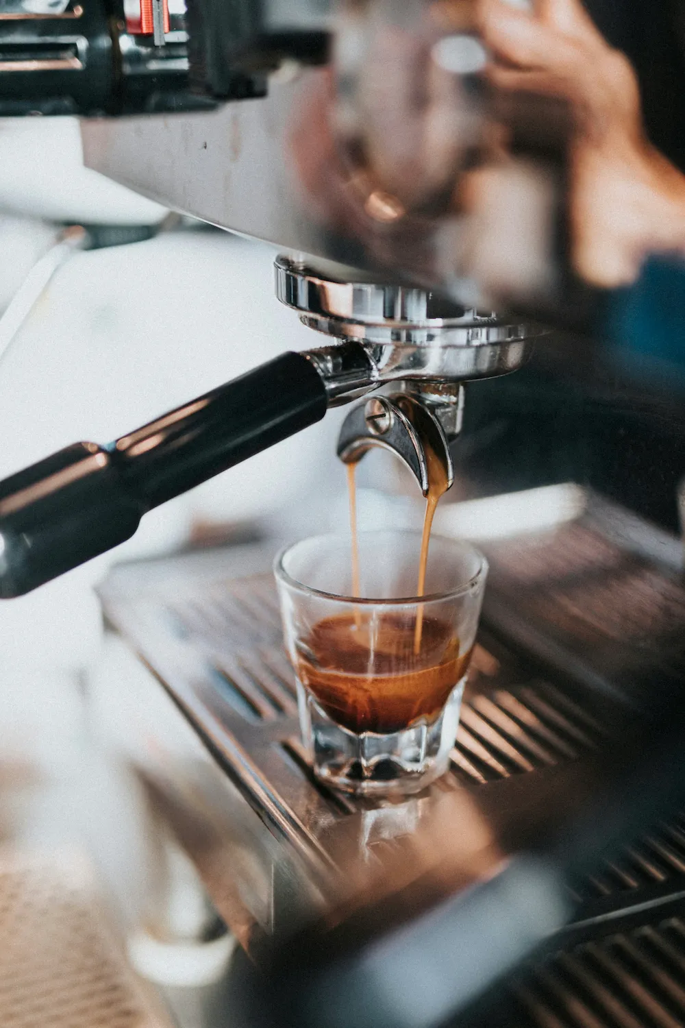 An espresso machine with a steam wand on a kitchen counter.