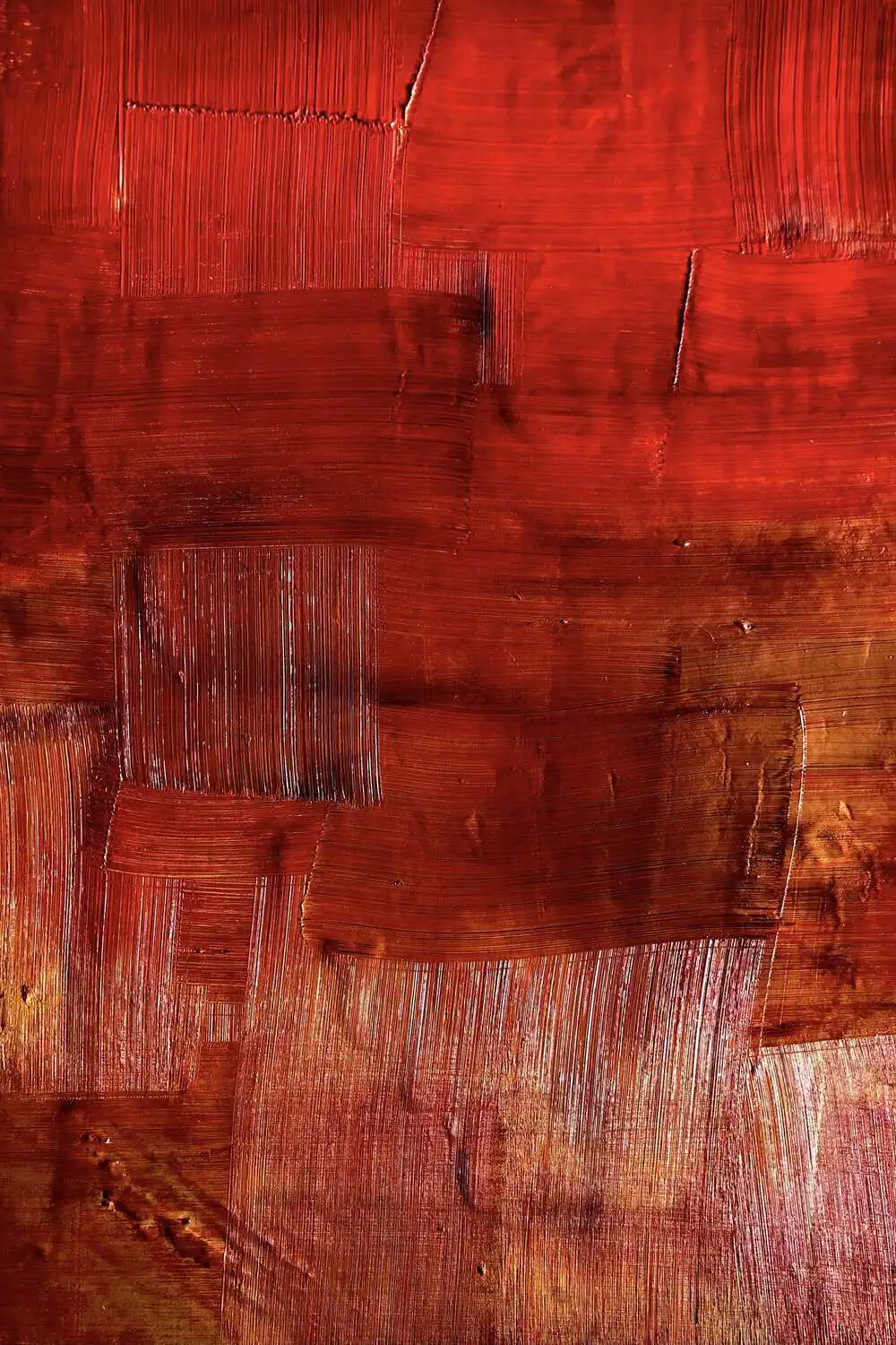 A ruby-toned painting on an easel in a sunlit studio.
