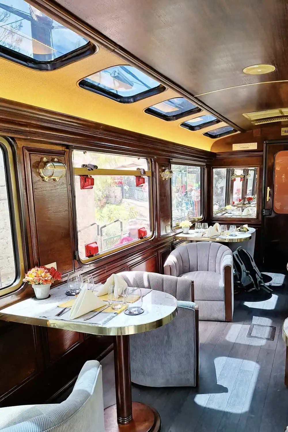A dining car table set for a scenic train ride through the countryside.
