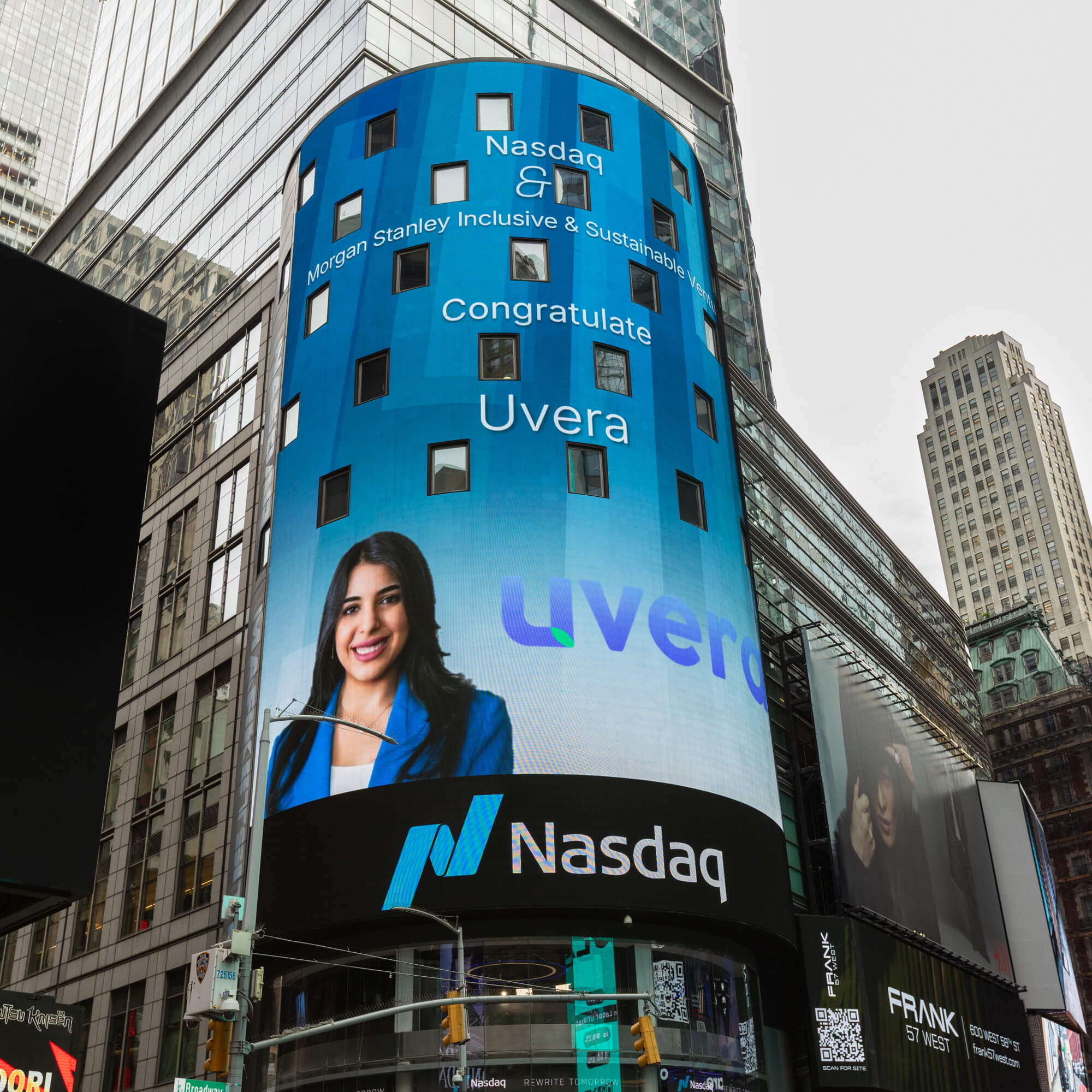 Large Nasdaq billboard congratulating Uvera with a woman in a blue blazer smiling.