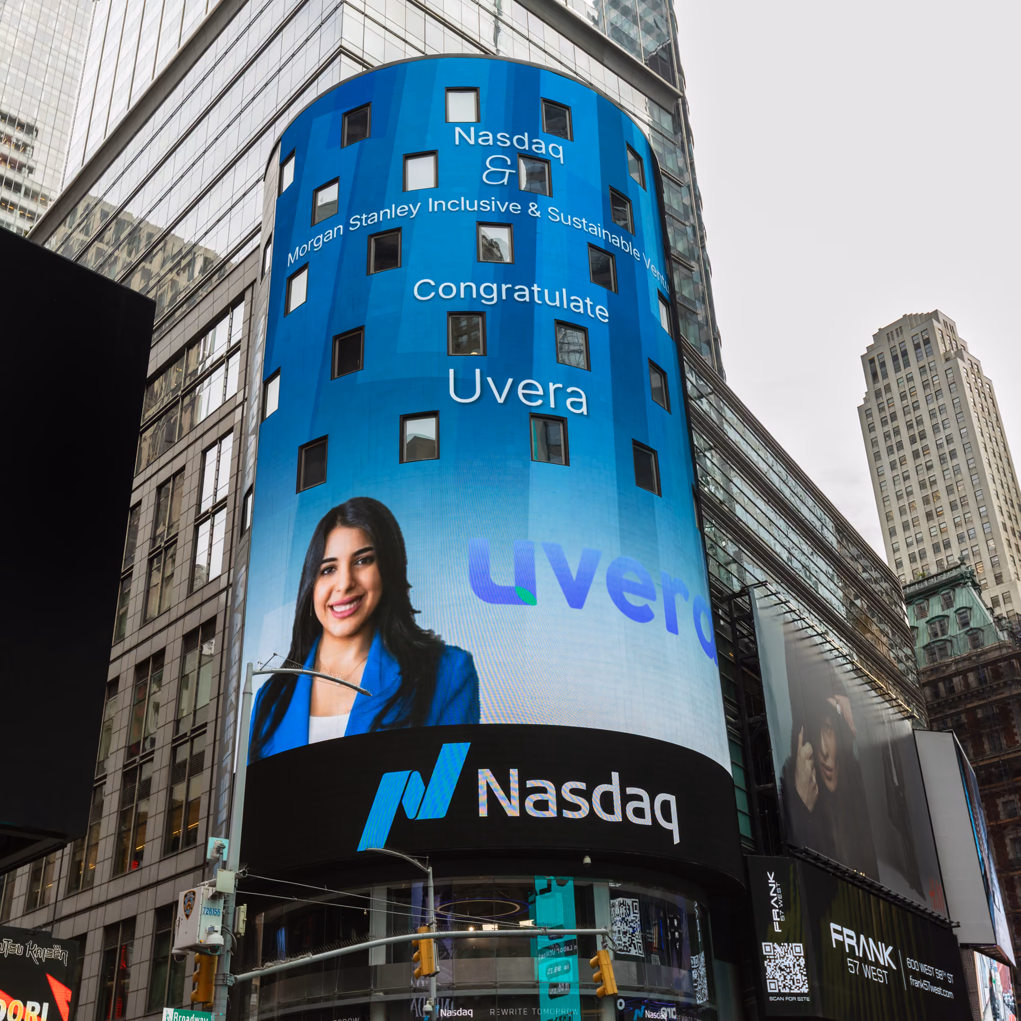 Large Nasdaq billboard congratulating Uvera with a woman in a blue blazer smiling.