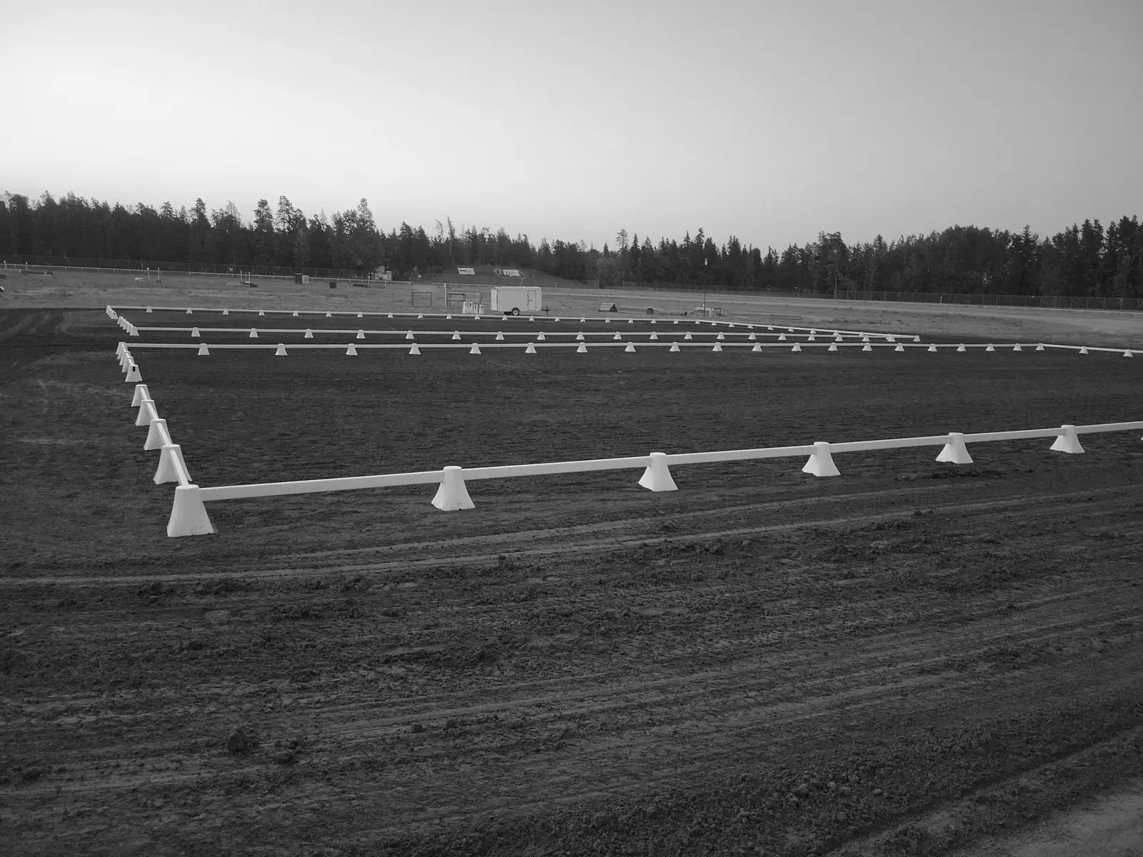 Empty dressage arena at dusk