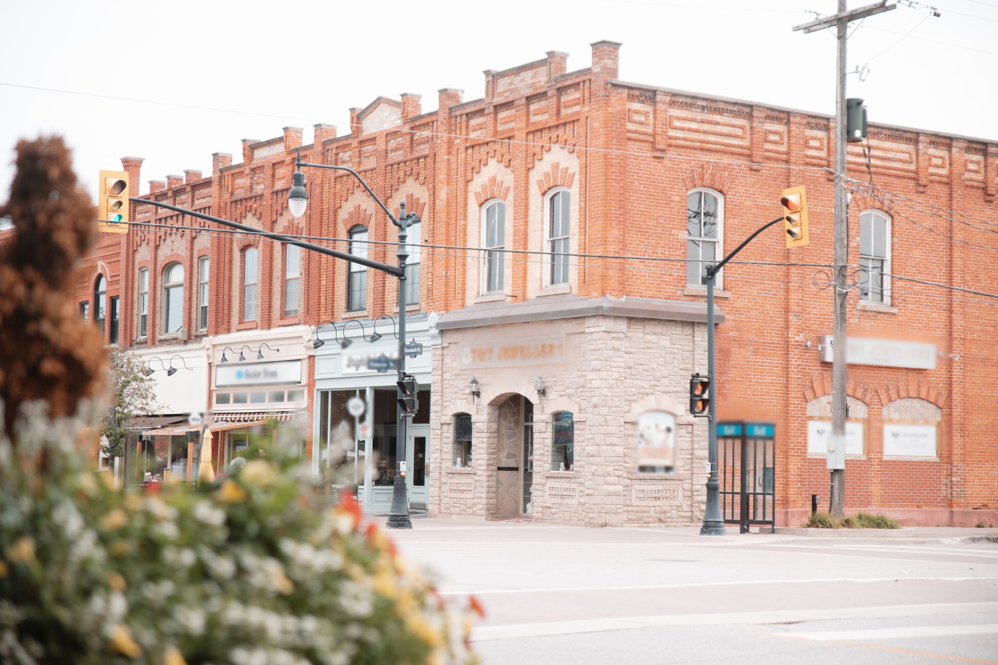 A row of independent storefronts on a small-town Main Street corner