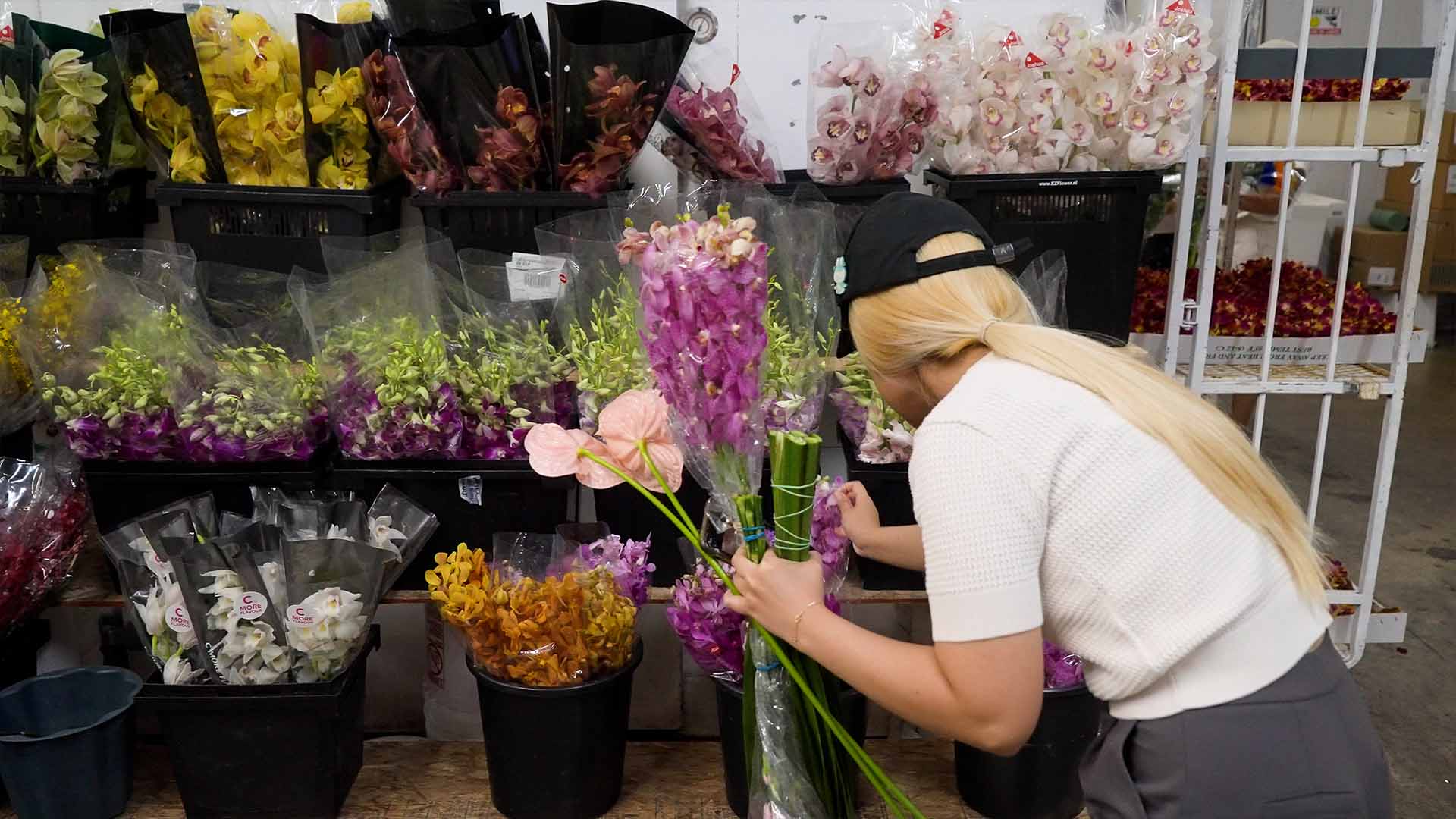 Customer selecting fresh flowers inside OC Wholesale Flowers