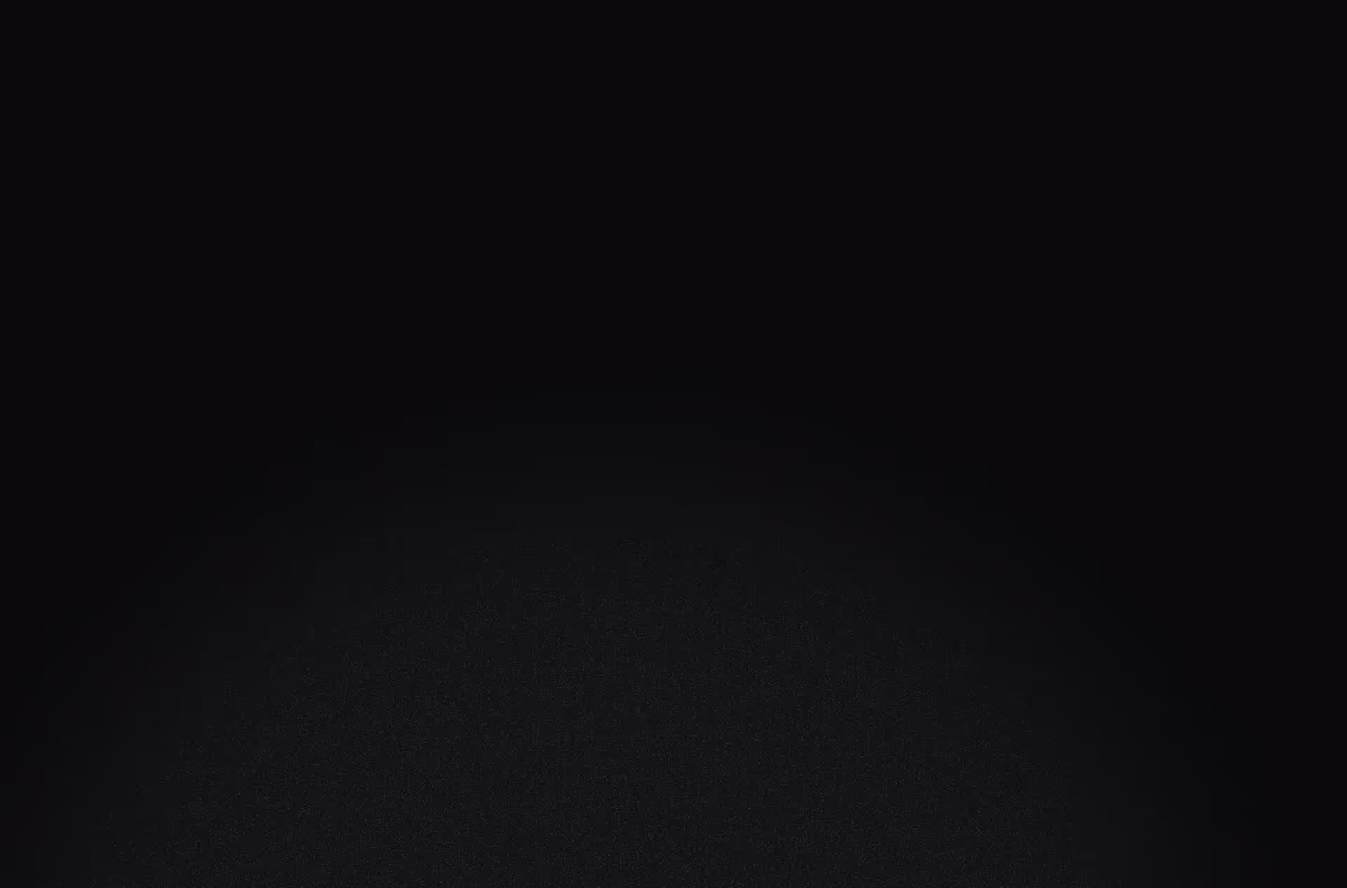 Dark texture with a subtle circular gradient fading from black to dark gray.