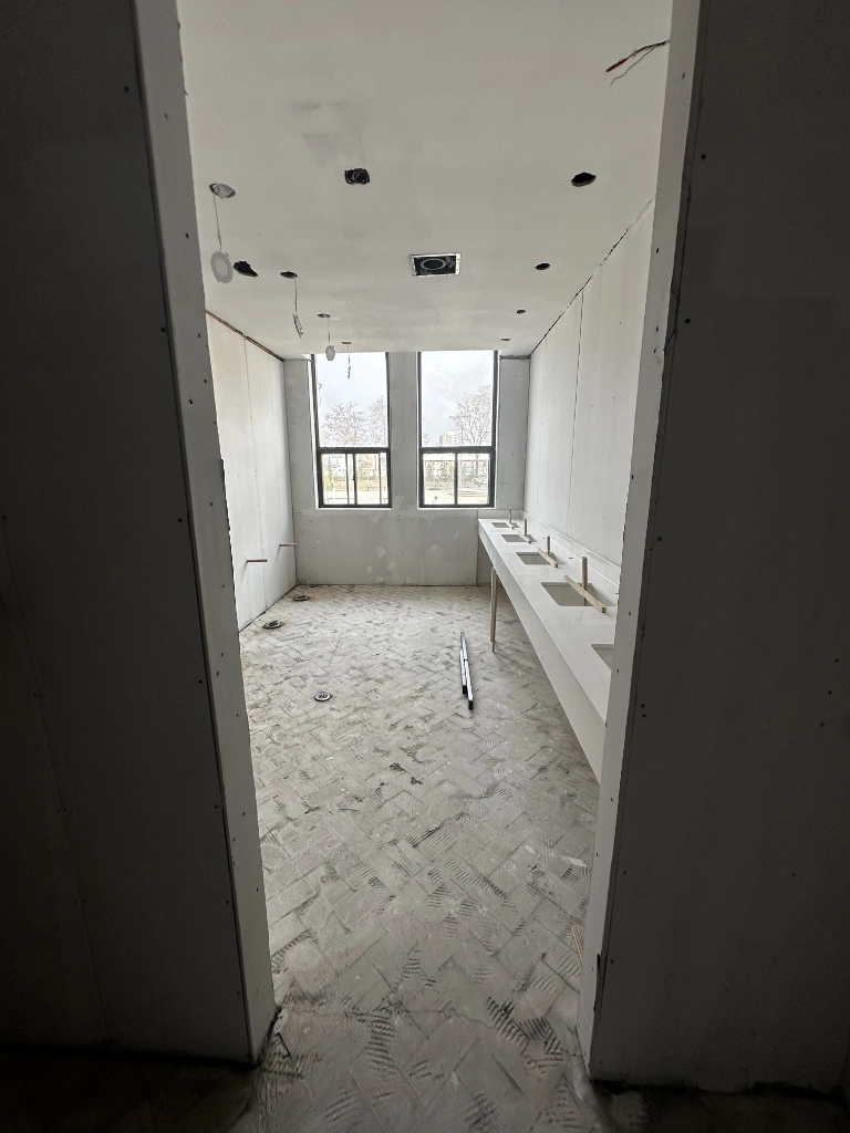 Early-stage commercial washroom renovation in the GTA — drywall and rough-in before tile and finishes.