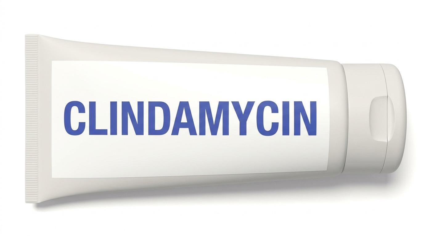 A white squeeze tube labelled Clindamycin, lying on its side with the cap to the right.