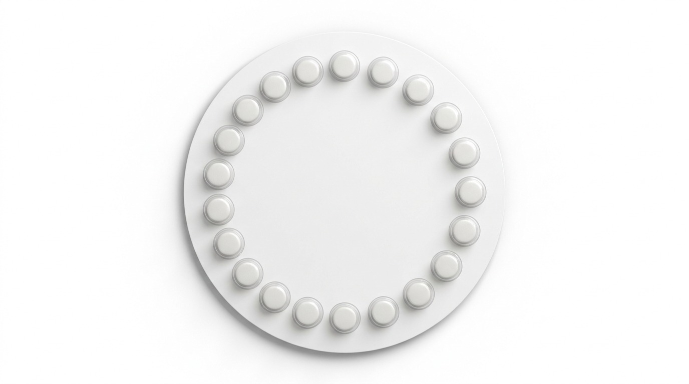 A round white blister pack of birth control pills, seen from above, tablets set in a ring.