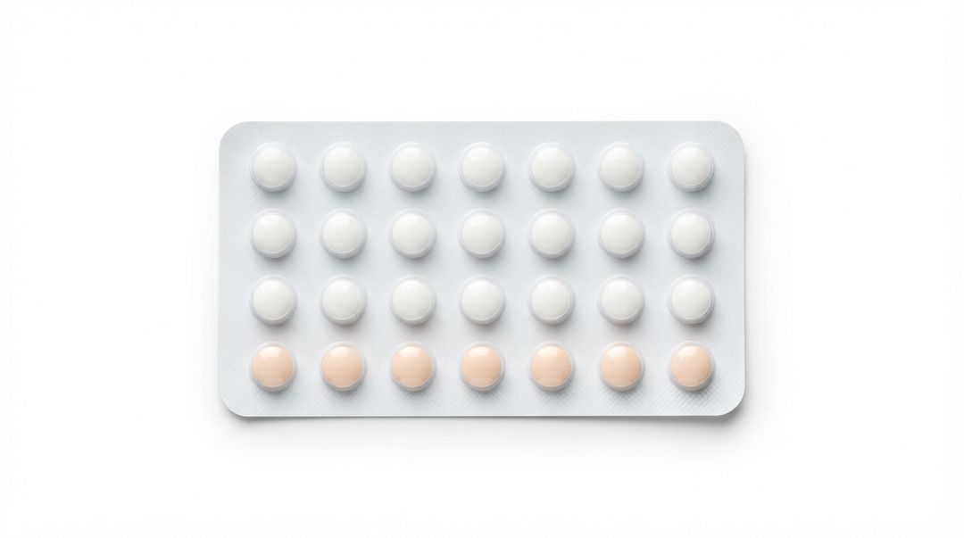 An unlabeled blister pack holding twenty-one white tablets and seven peach ones in four rows
