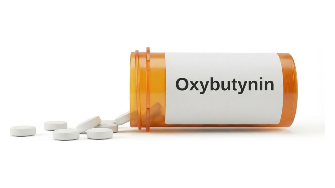 An amber prescription bottle lying on its side on a white background with a plain white label reading Oxybutynin, and six small round white tablets spilled out in front of it.