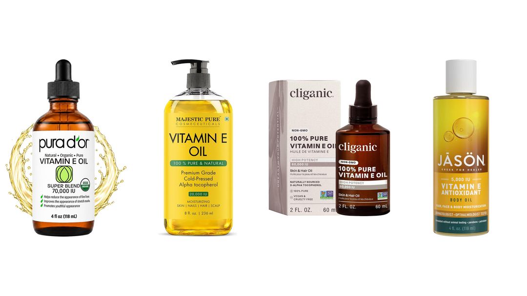 Four vitamin E oil bottles lined up on white, two amber dropper bottles and two clear yellow oils