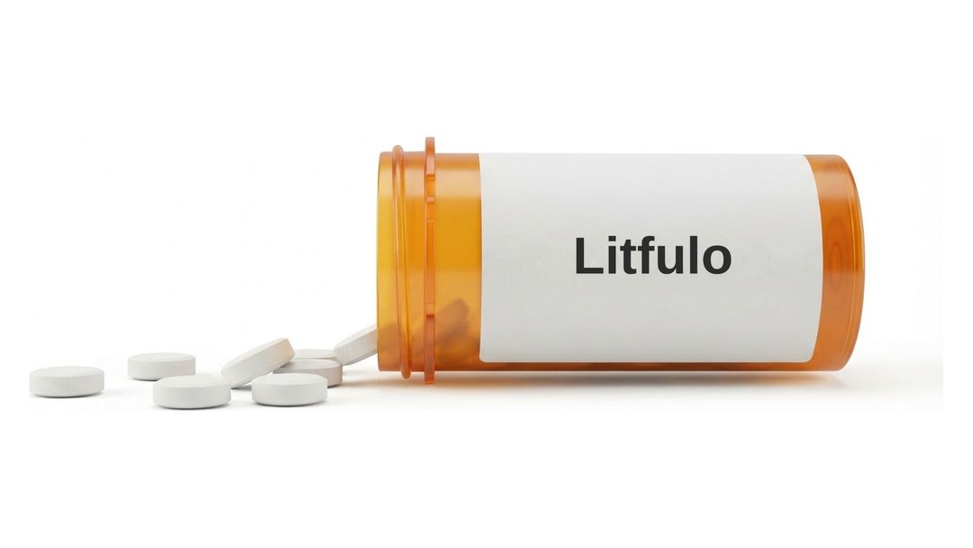 An amber prescription bottle lying on its side on a white background with a plain white label reading Litfulo, and six small round white tablets spilled out in front of it.