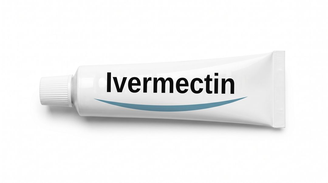 A white cream tube lying on its side on a white background, with a plain white label reading Ivermectin and a blue swoosh beneath it.