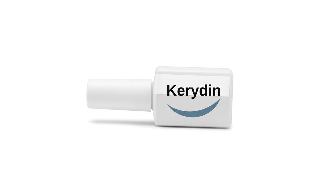 A white nail lacquer bottle on a white background, with a plain white label reading Kerydin and a blue swoosh beneath it.