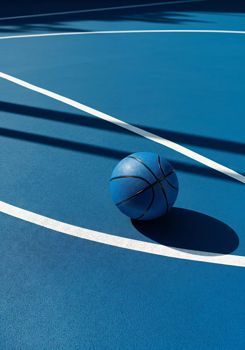 Blue basketball resting on a blue court with white curved lines and shadows.