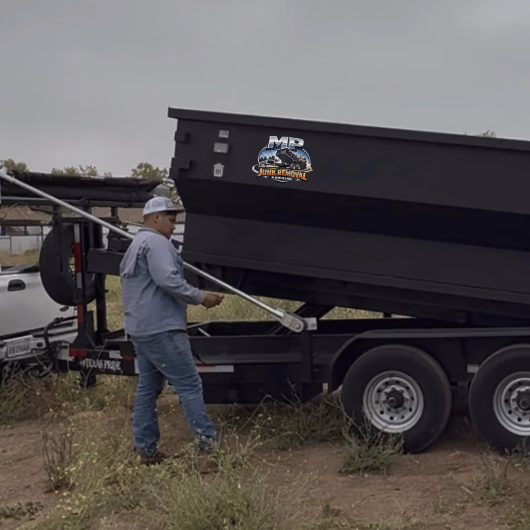 Martin, owner of MP Junk Removal & Hauling operating his trailer on the job site.