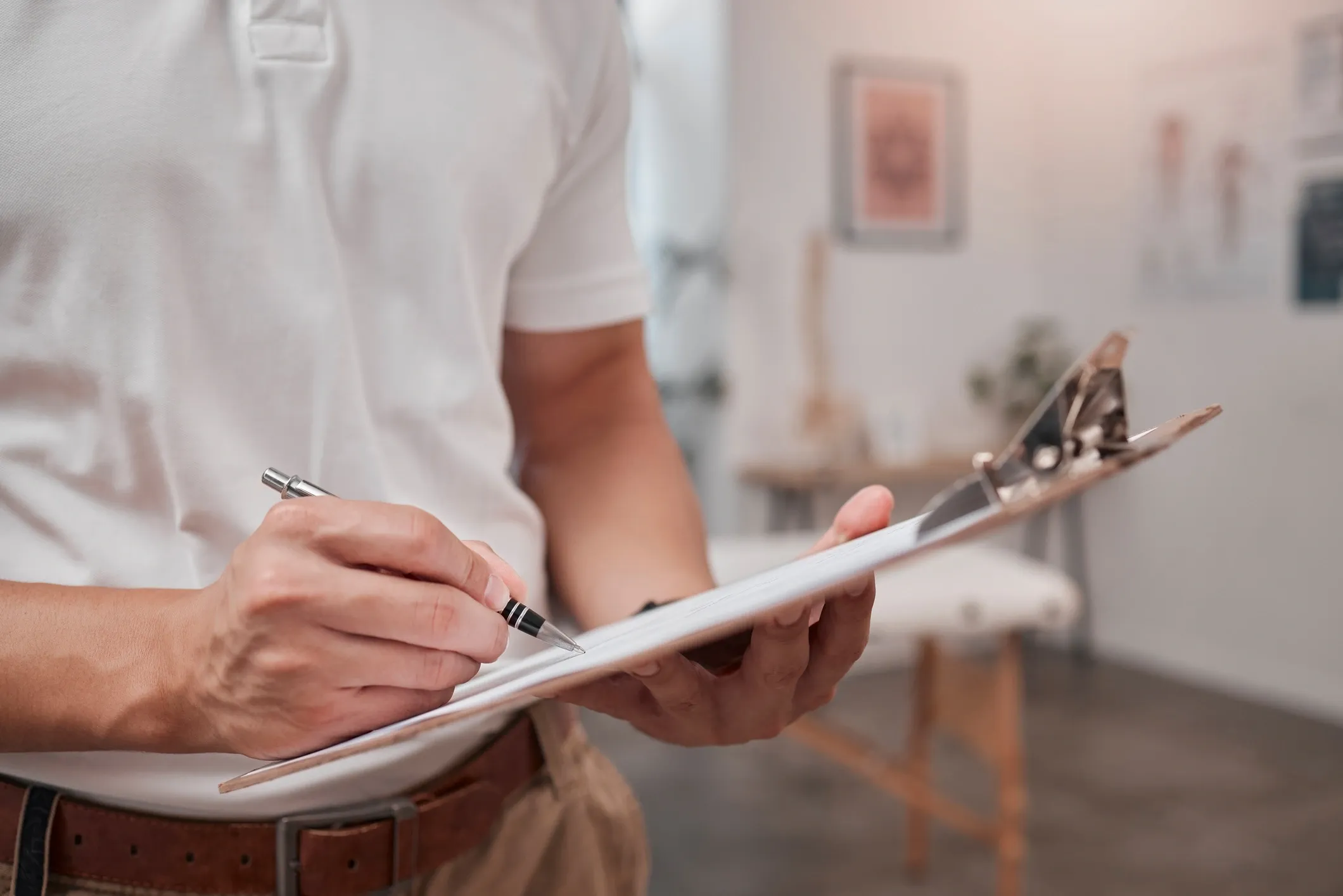 Property manager reviewing work details with a clipboard during contractor supervision