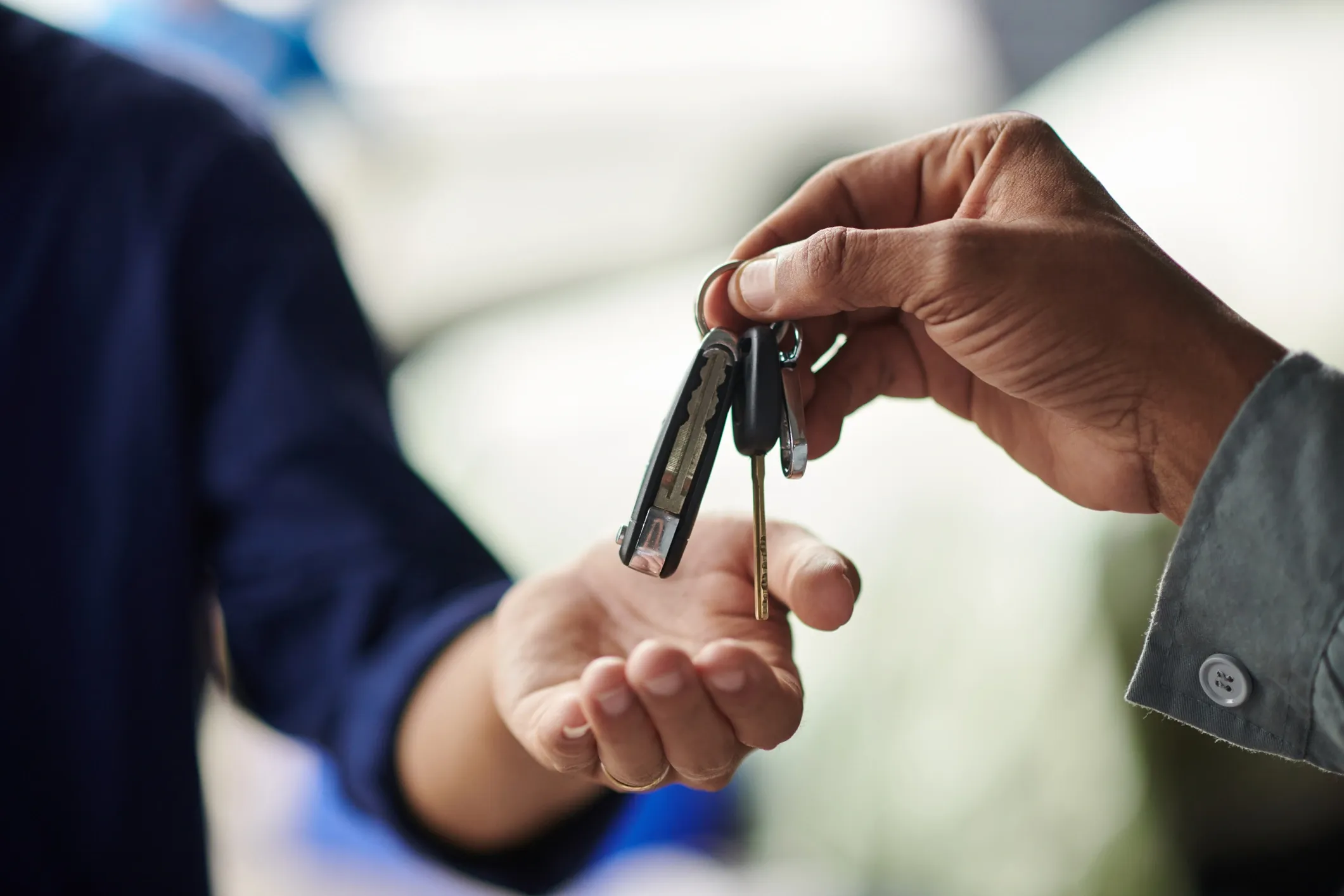 Property manager handing house keys to a guest for secure access