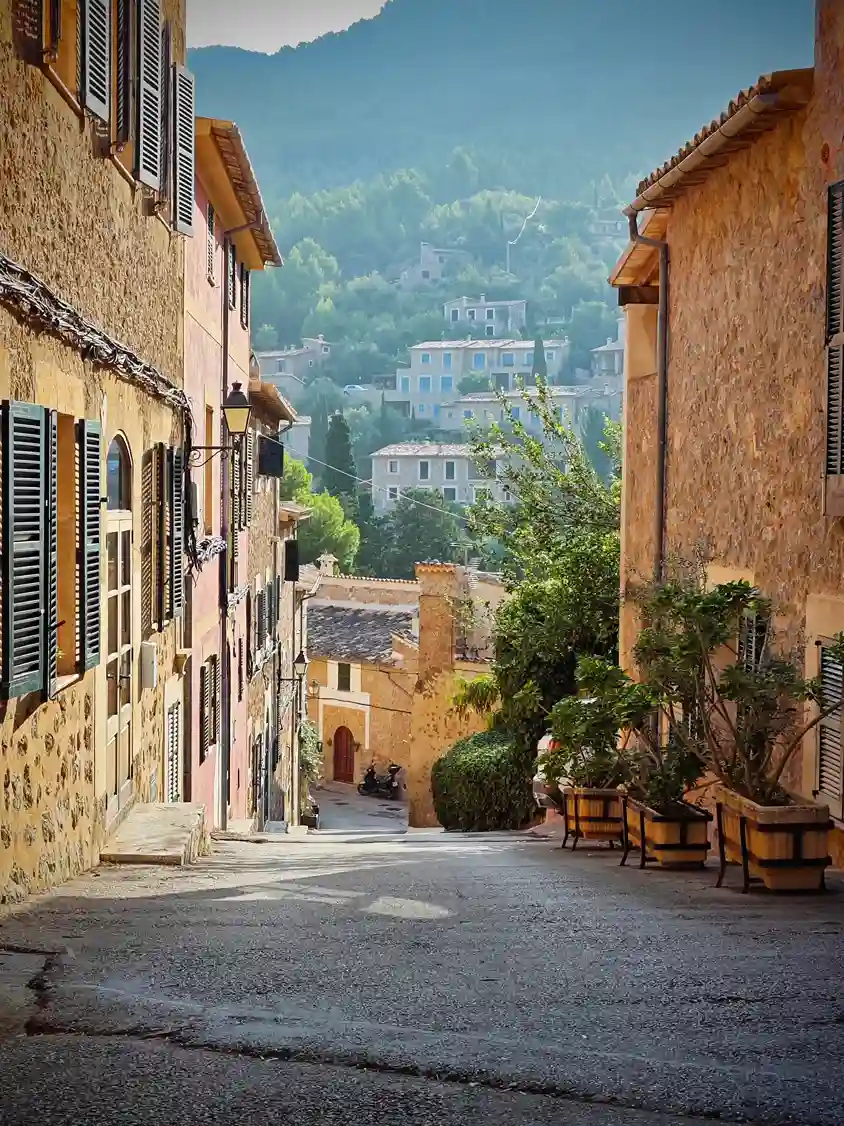 Traditional village street with stone houses and shutters in Mallorca, Spain
