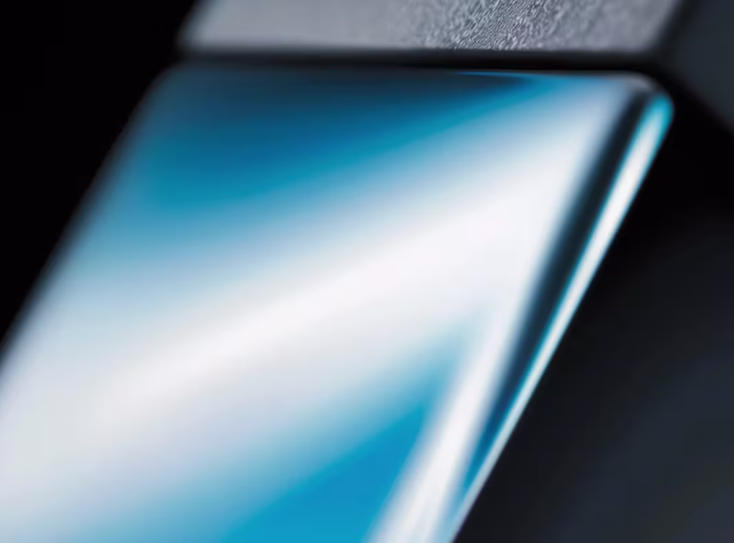 Close-up of a reflective dark phone screen with a diagonal light streak