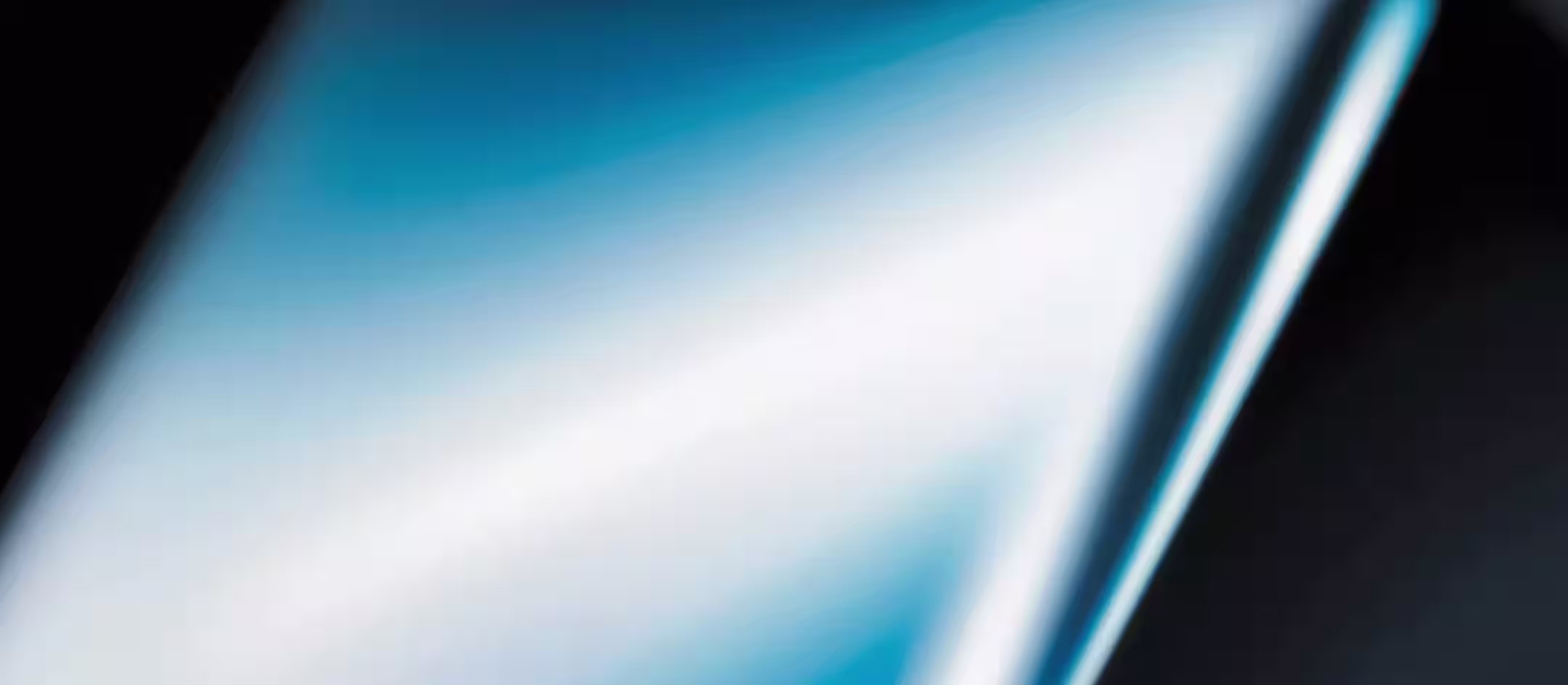 Close-up of a reflective dark phone screen with a diagonal light streak