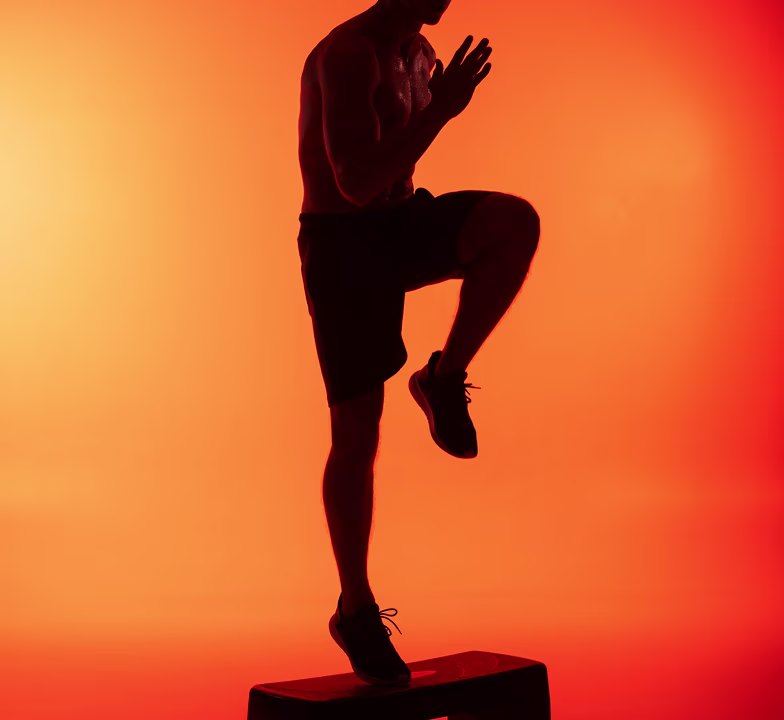 Motion-blurred silhouette of a figure in dynamic movement against warm light streaks