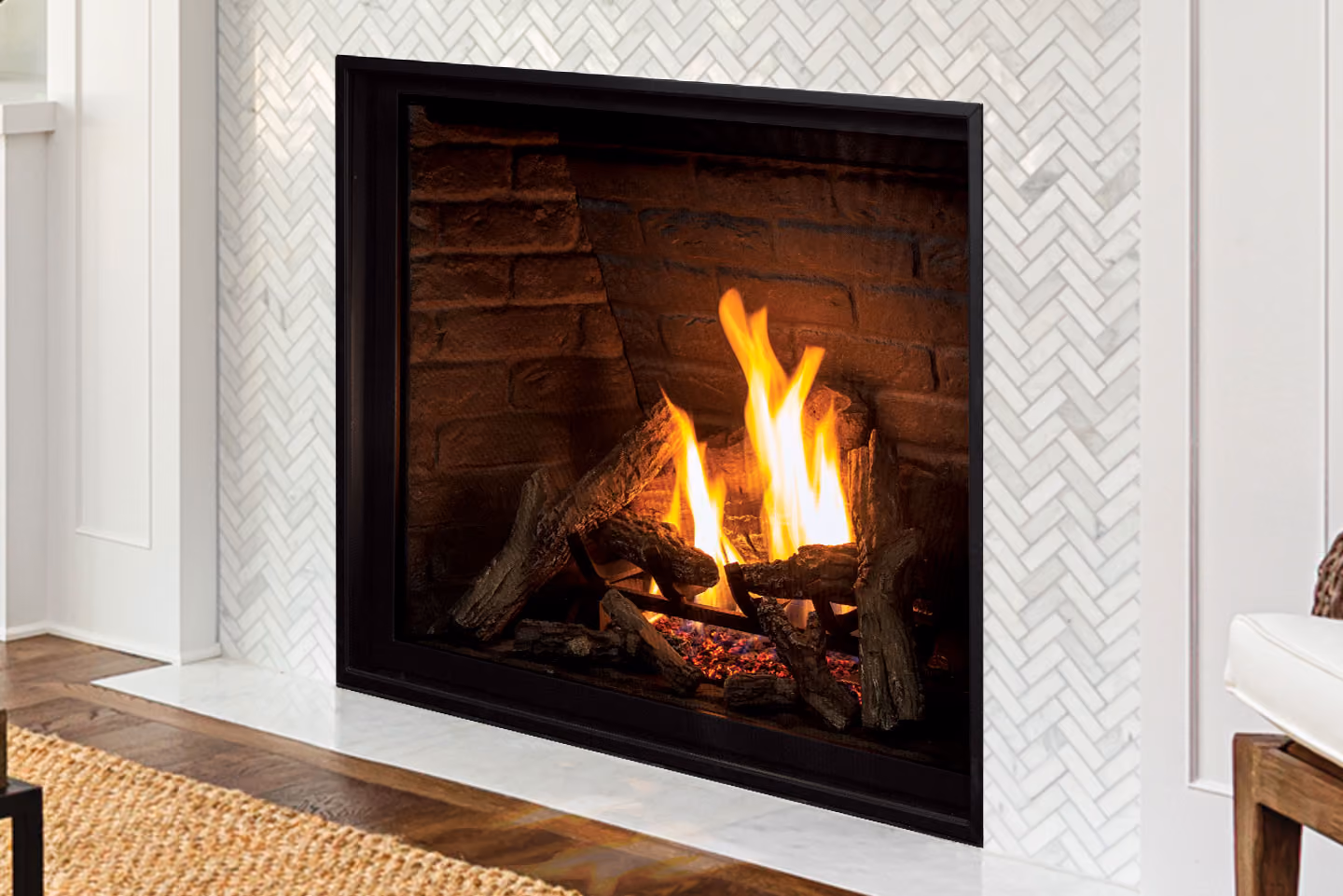 Modern fireplace with burning logs and flames surrounded by white herringbone tile and wood floor.