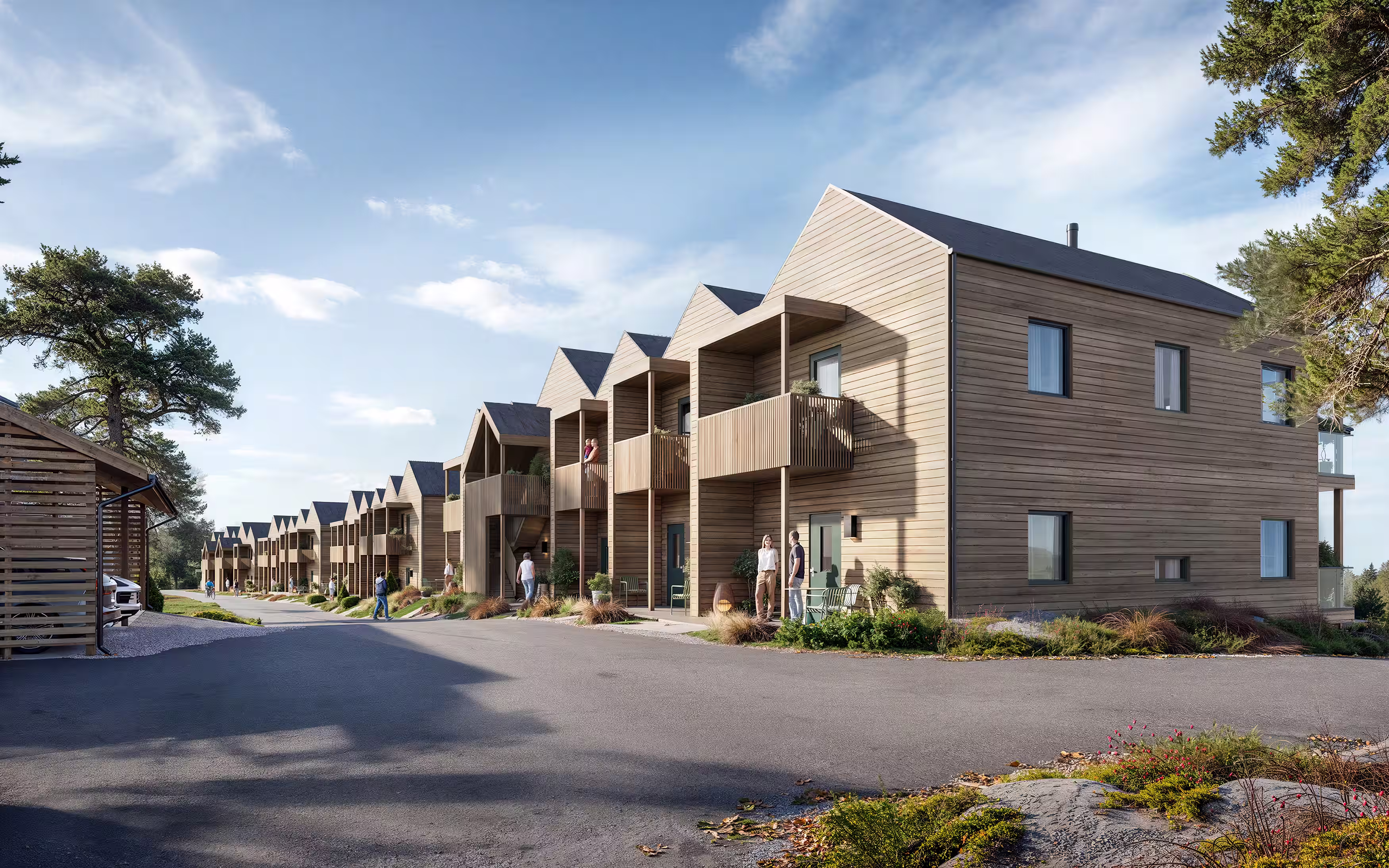 Row of modern two-story wooden houses with balconies on a sunny day.