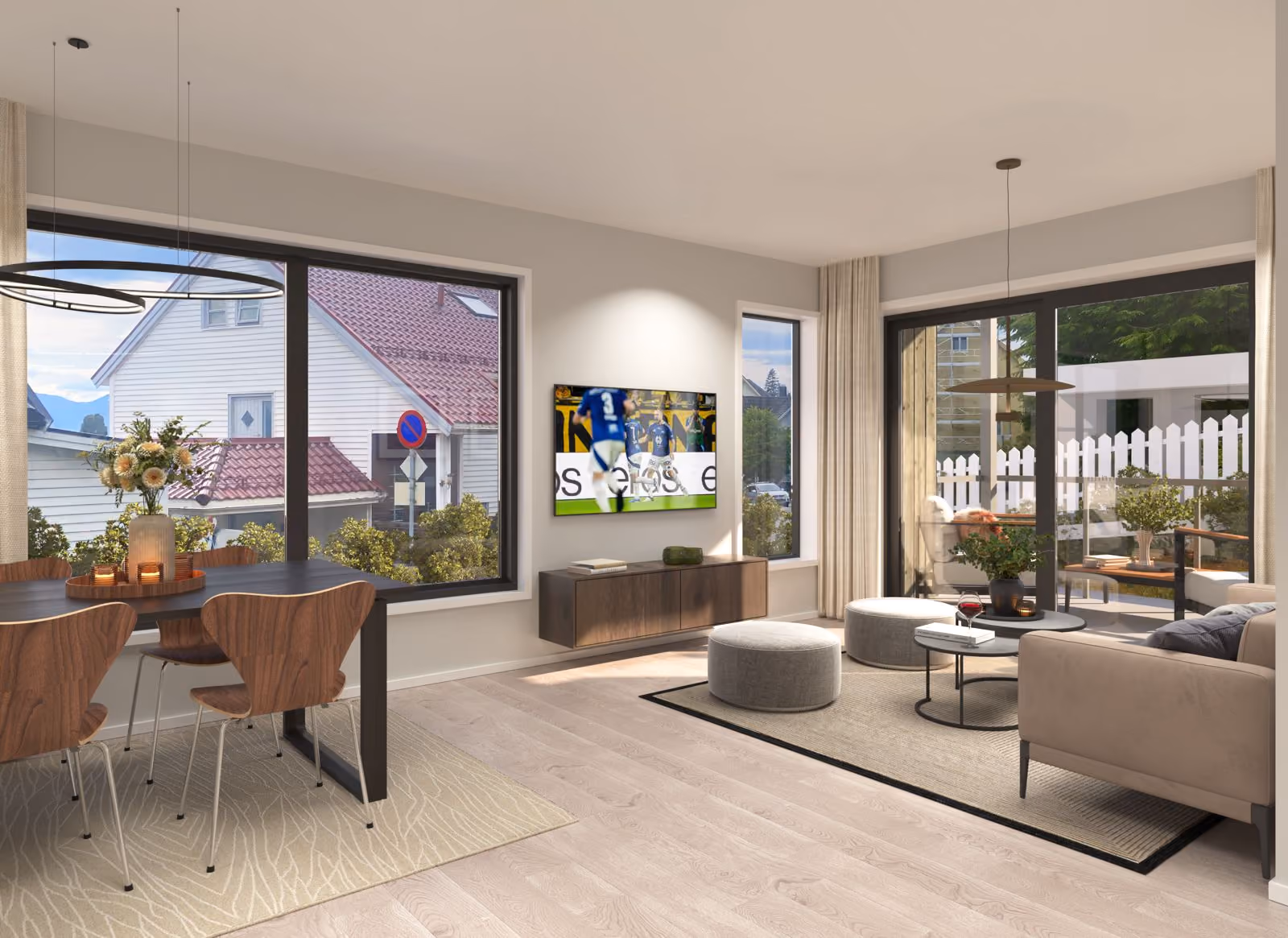 Modern living room and dining area with large windows, flat-screen TV, and patio seating outside.