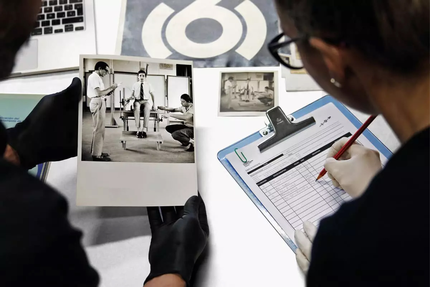 A shot of two people examining files