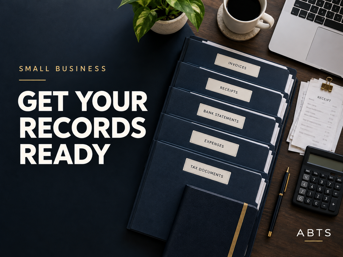 Organized navy business-record folders, receipts, calculator, ledger, and laptop arranged on a professional desk.